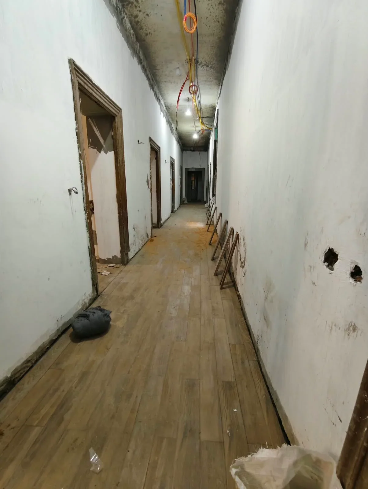 Corridor floor installation with wall finishing still in progress