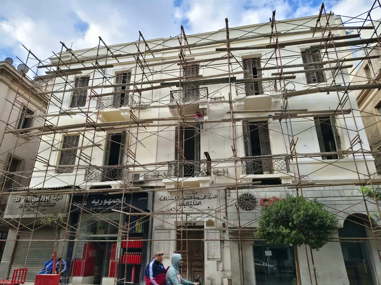 Building facade during renovation with scaffolding across its storeys